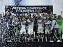 Ryan Gauld #25 and Edier Ocampo #18 of the Vancouver Whitecaps FC lift the Champion's trophy after winning the the Audi 2025 MLS Cup western conference final match between San Diego FC and Vancouver Whitecaps FC at Snapdragon Stadium on November 29, 2025 in San Diego, California.