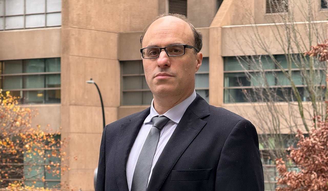 Man in suit standing, facing camera