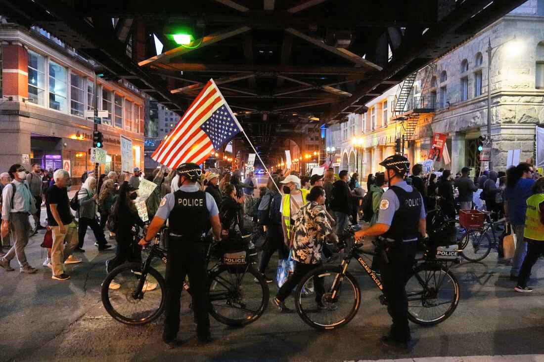 Police officers block a street as demonstrators march at a protest opposing "Operation Midway Blitz" and the presence of ICE, Sept. 9, 2025, in Chicago.