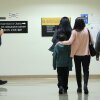 People walk past a federal agent as he patrol the halls of immigration court at the Jacob K. Javitz Federal Building on October 15, 2025 in New York City. Michael M. Santiago/Getty Images)