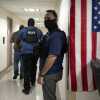 Federal agents stand outside an immigration court at the Jacob K. Javits federal building in New York in September 2025.