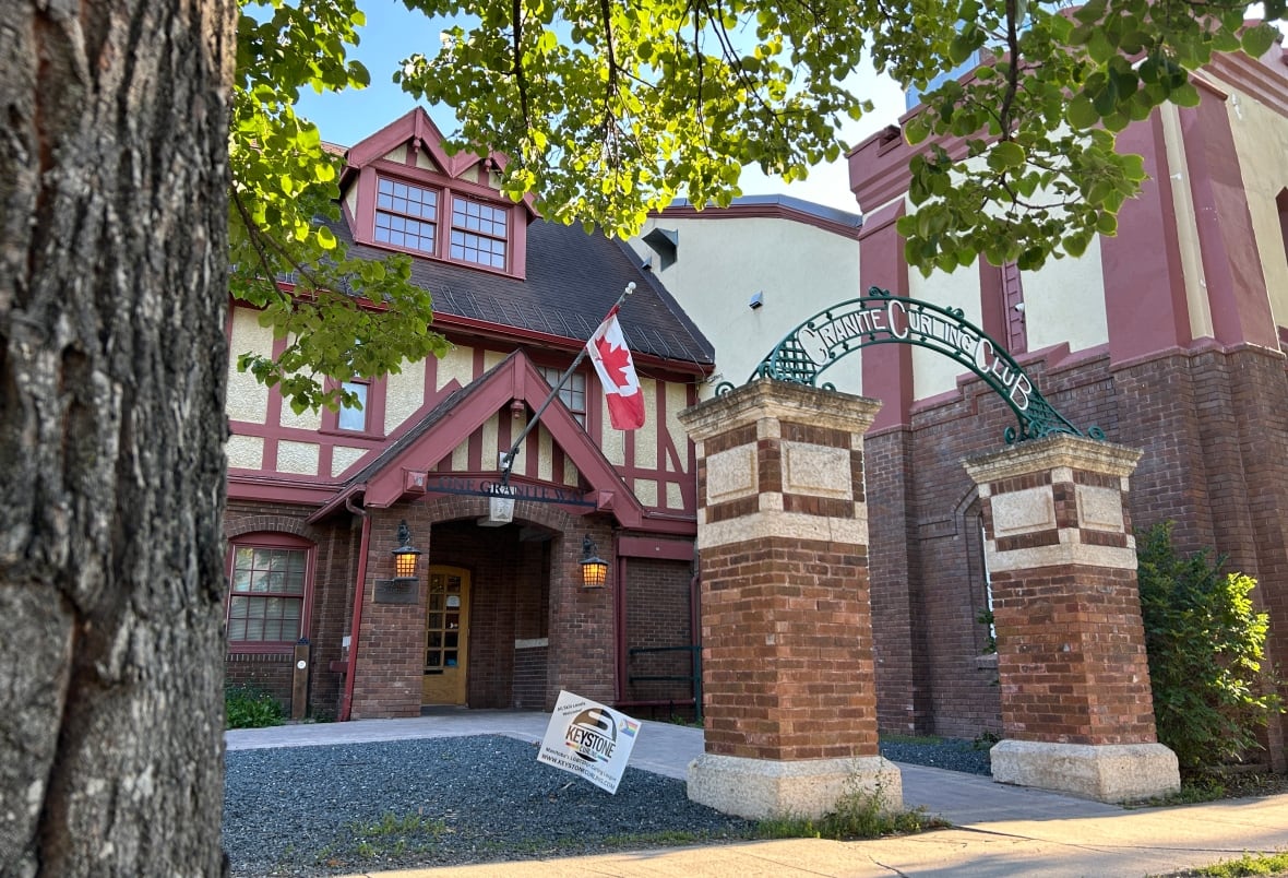 The exterior of a building with a sign reading "Granite Curling Club."