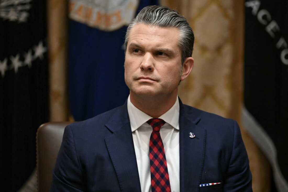 Secretary of Defense Pete Hegseth listens as President Donald Trump speaks during a Cabinet Meeting at the White House on Dec. 2.