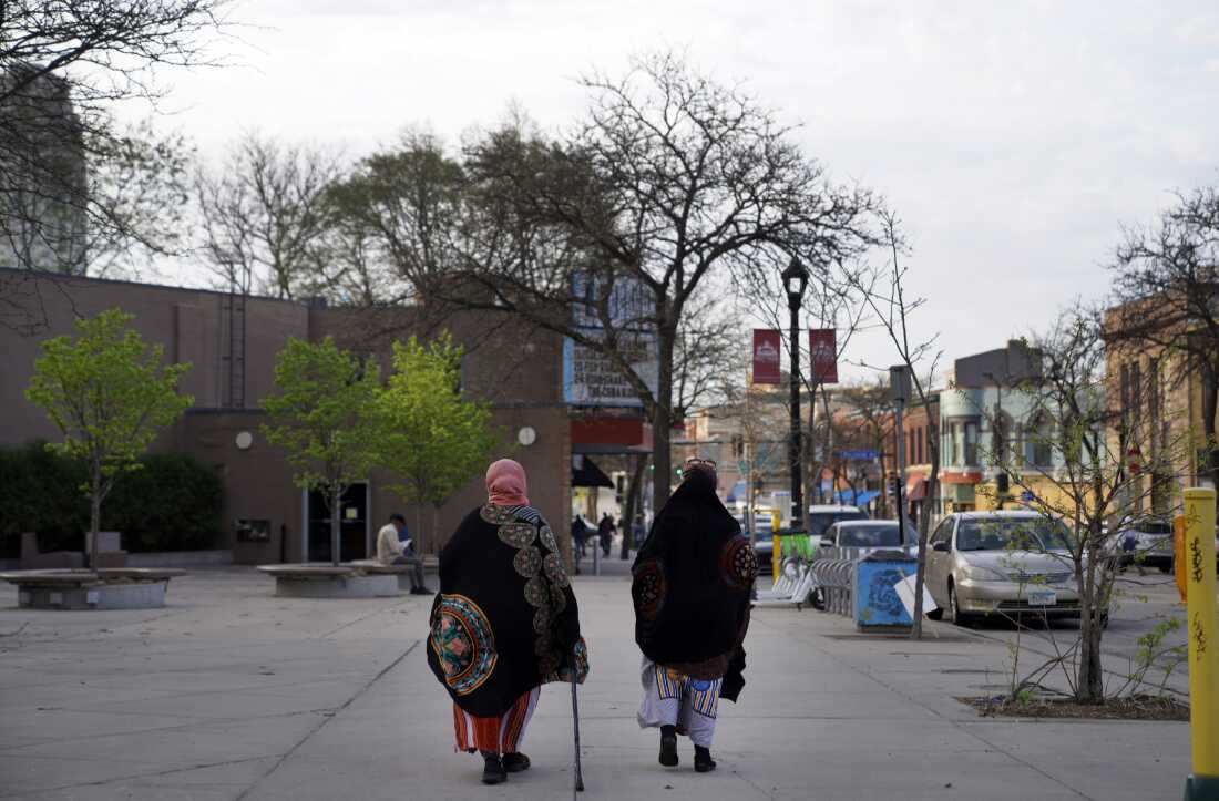 Women walk down a street in the predominantly Somali neighborhood of Cedar-Riverside in Minneapolis in 2022. The Twin Cities is a hub for Somalis in the U.S.