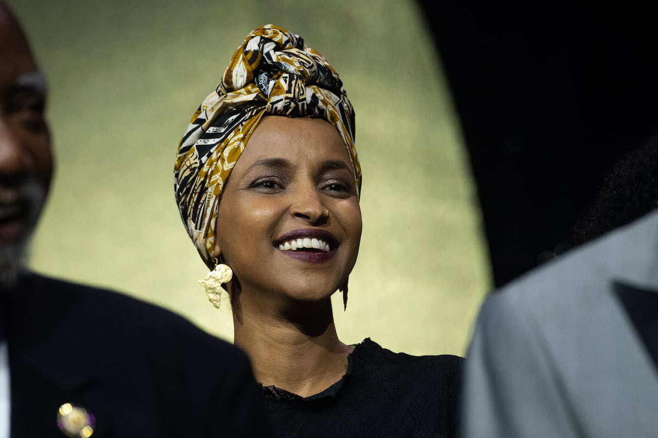 A woman in a headdress smiles