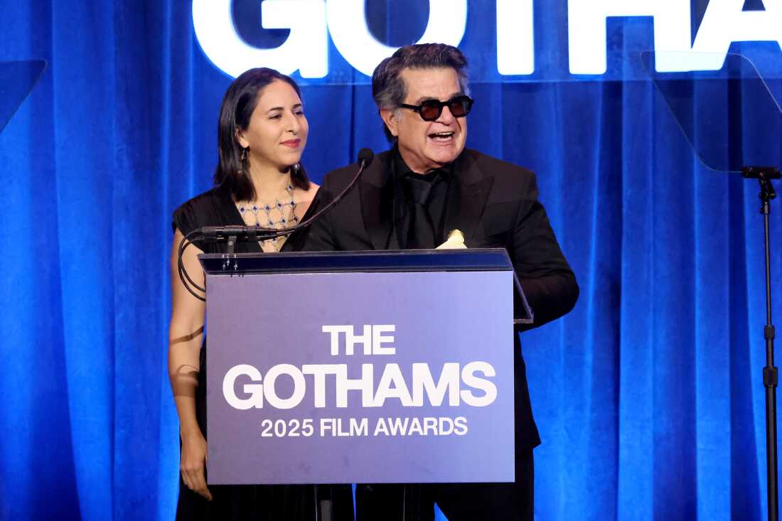 Alongside interpreter Sheida Dayani, filmmaker Jafar Panahi accepts the award for the best original screenplay at the Gotham Awards in New York on Monday for his film It Was Just an Accident.