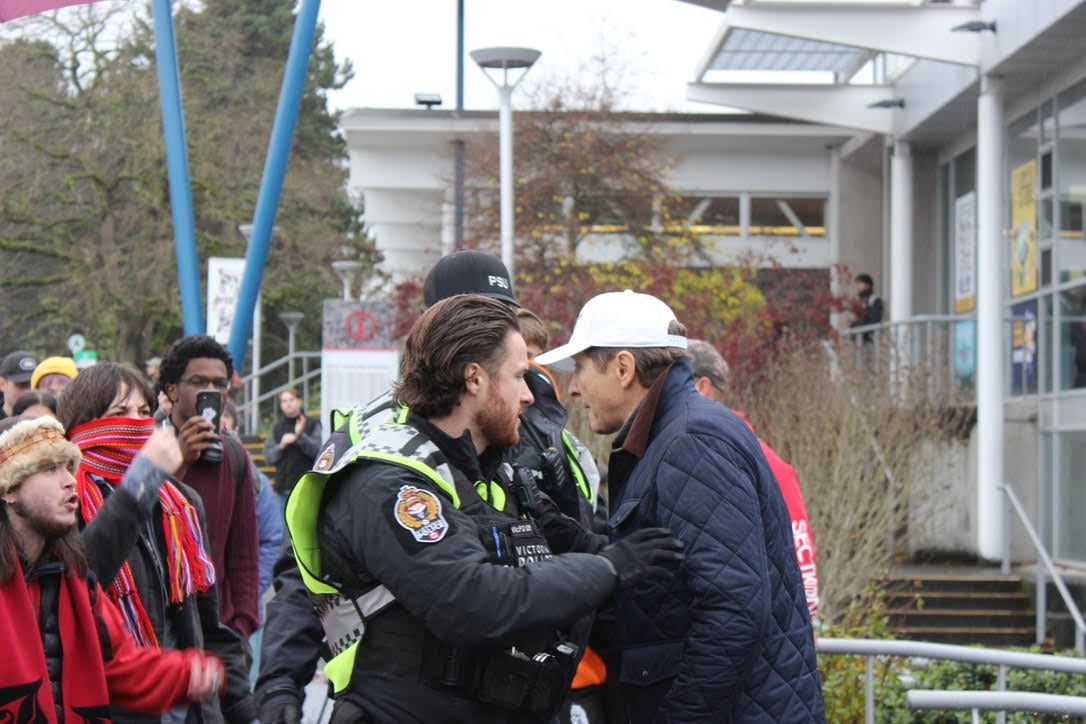 a man being escorted by police