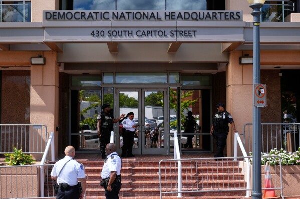 Members of law enforcement are pictured outside Democratic National Committee headquarters, Sept. 11, 2025, in Washington. (AP Photo/Mark Schiefelbein, File)