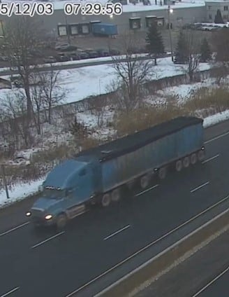 Police have identified the suspect vehicle in the crash as a blue commercial tractor and trailer with a black tarp on top. 