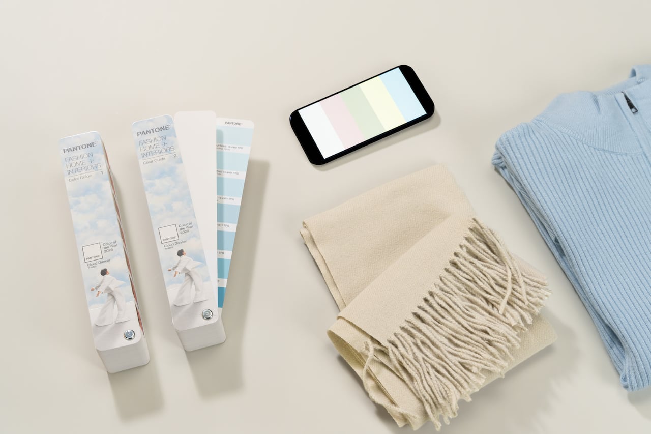 Paint swatches, a white scarf, and a  blue sweater