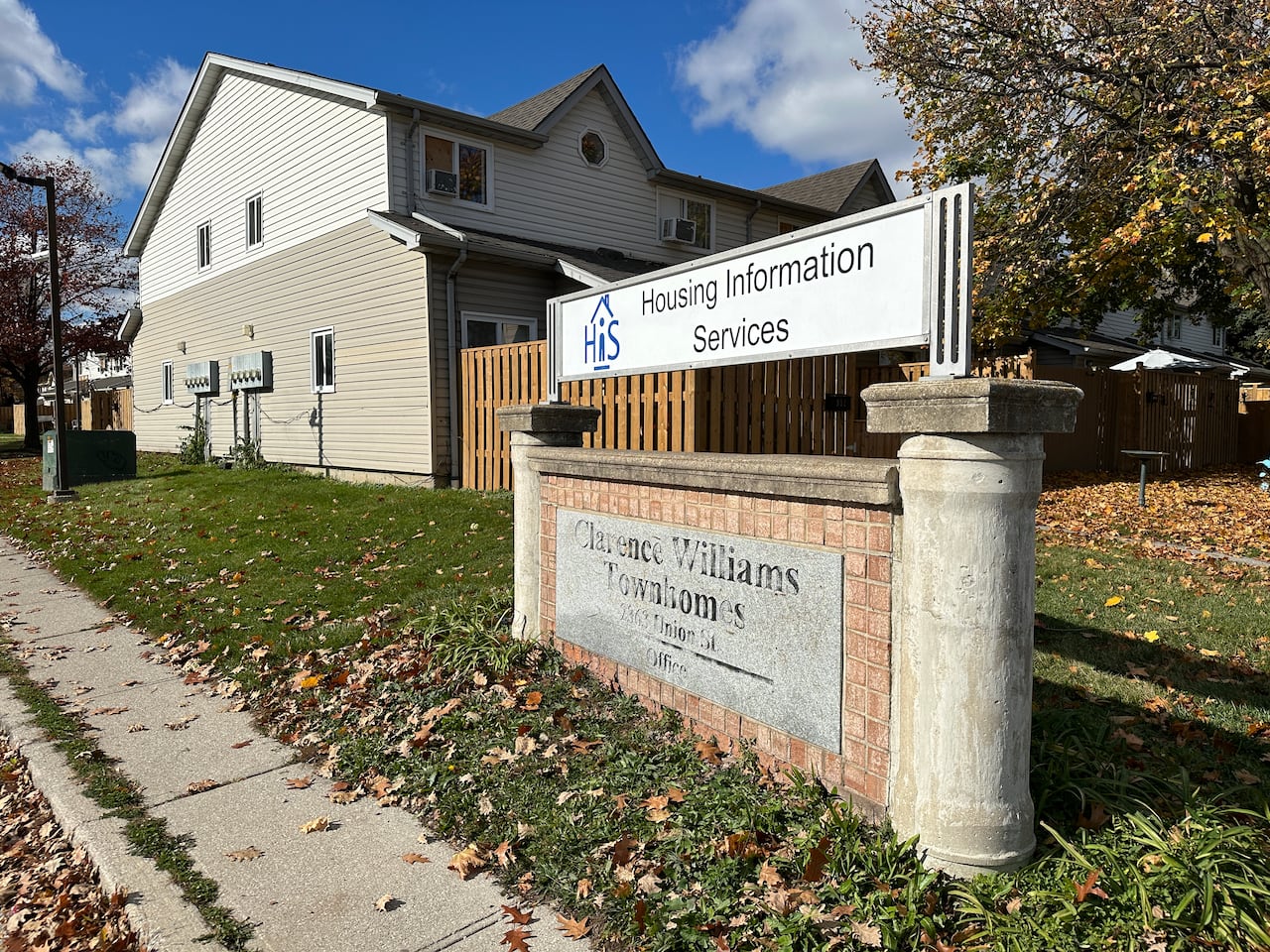 A sign that says Housing Information Services and Clarence William Townhomes.