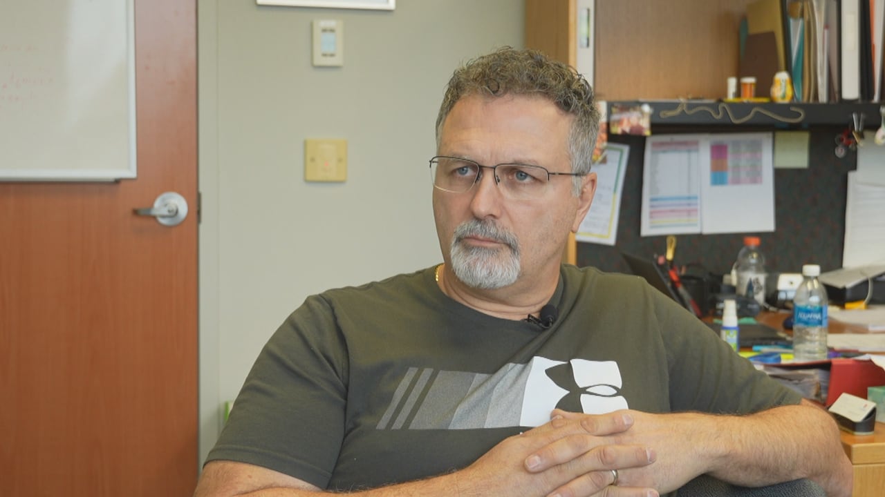 A man in a t-shirt wearing glasses.