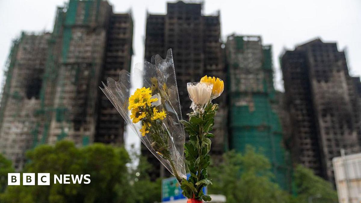 A bouquet of flowers is seen in front of the Wang Fuk Court in the aftermath of the deadly fire in Hong Kong's Tai Po district