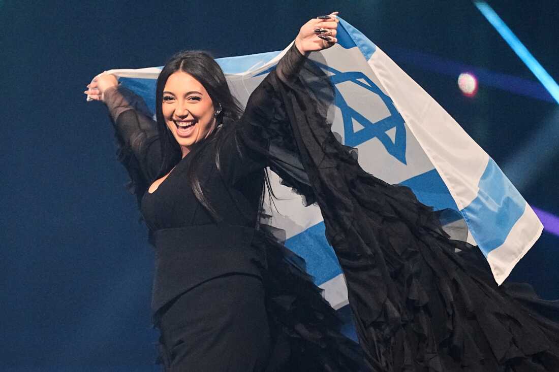 FILE - Singer Yuval Raphael, from Israel, holds the national flag during a dress rehearsal for the Grand Final of the 69th Eurovision Song Contest, May 16, 2025, in Basel, Switzerland.