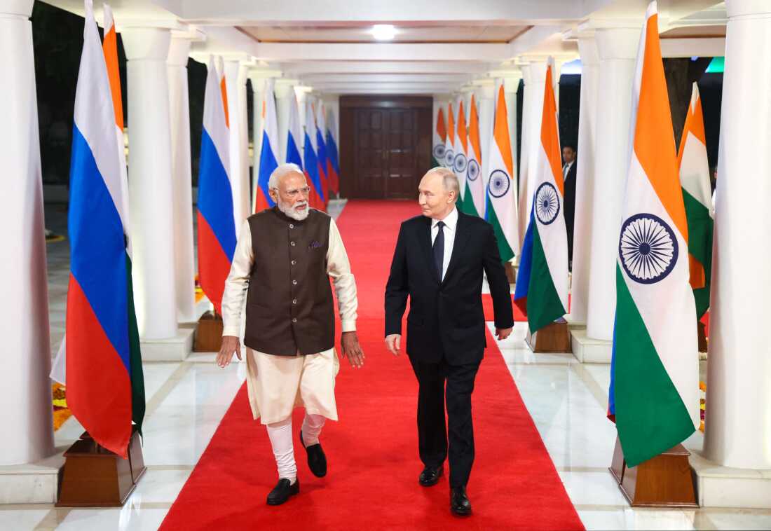 In this pool photograph distributed by the Russian state agency Sputnik, Russia's President Vladimir Putin and Indian Prime Minister Narendra Modi walk prior to an informal dinner at Modi's residence in New Delhi on Thursday, the first day of the Russian leader's two-day state visit to India. (Photo by Alexander KAZAKOV / POOL / AFP via Getty Images)