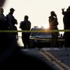 Members of law enforcement stand in the road, blocks from the White House, at the site where two West Virginia National Guard members were shot on November 26, 2025.