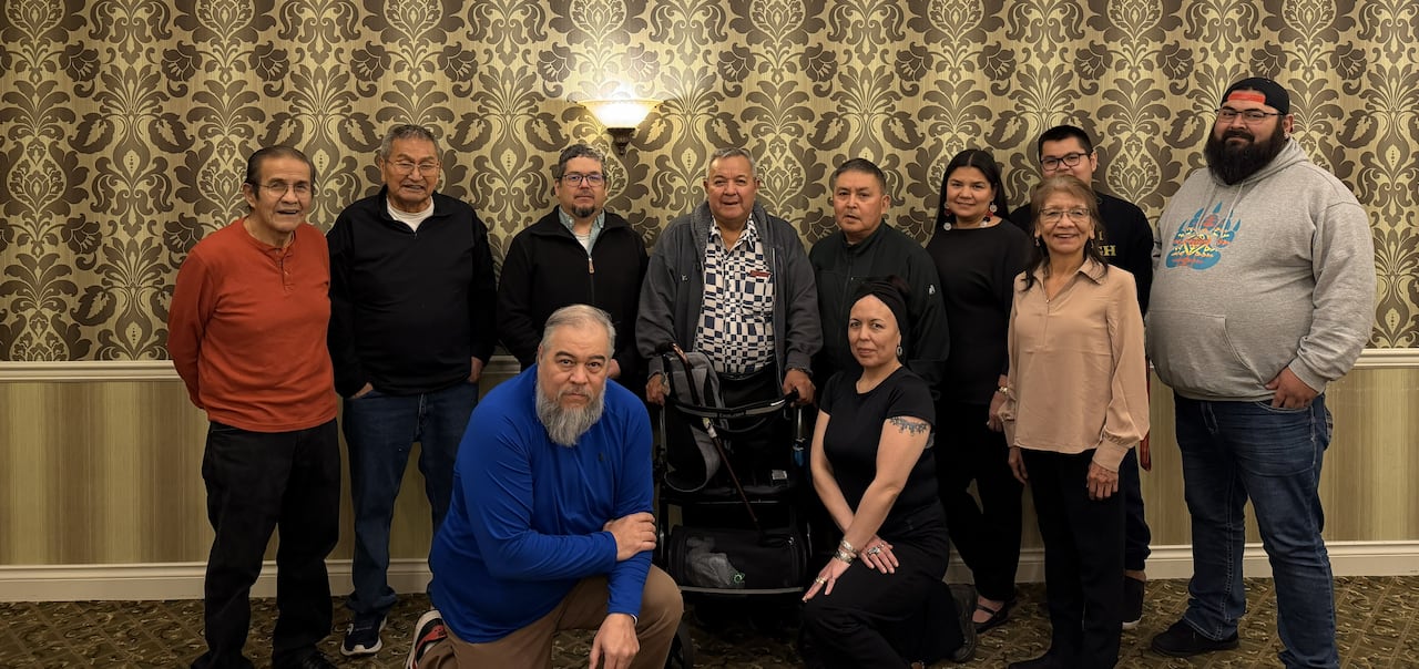 A group of people pose and smile.