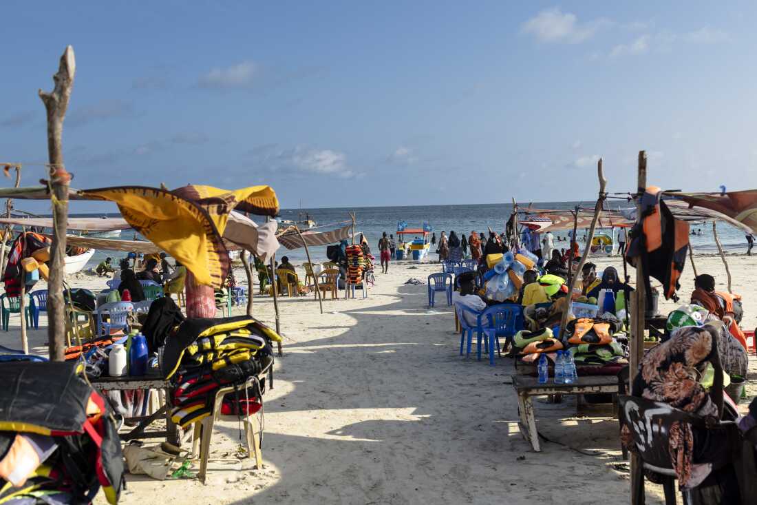 Vendors hawking food and flotation devices wait for visitors at Lido beach in Mogadishu on Nov. 10, 2025. 