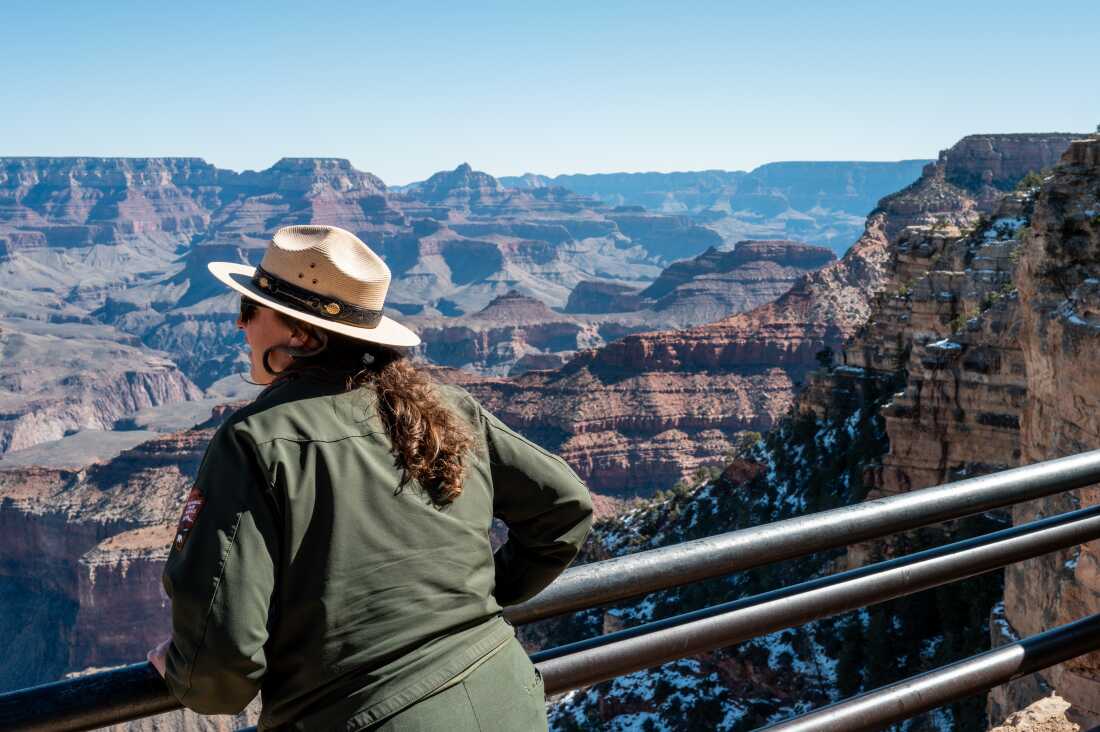 Grand Canyon Park Services Ranger Jill Staurowsky looks out from the South Rim while giving a tour to visitors on February 22, 2025 in Grand Canyon, Arizona.