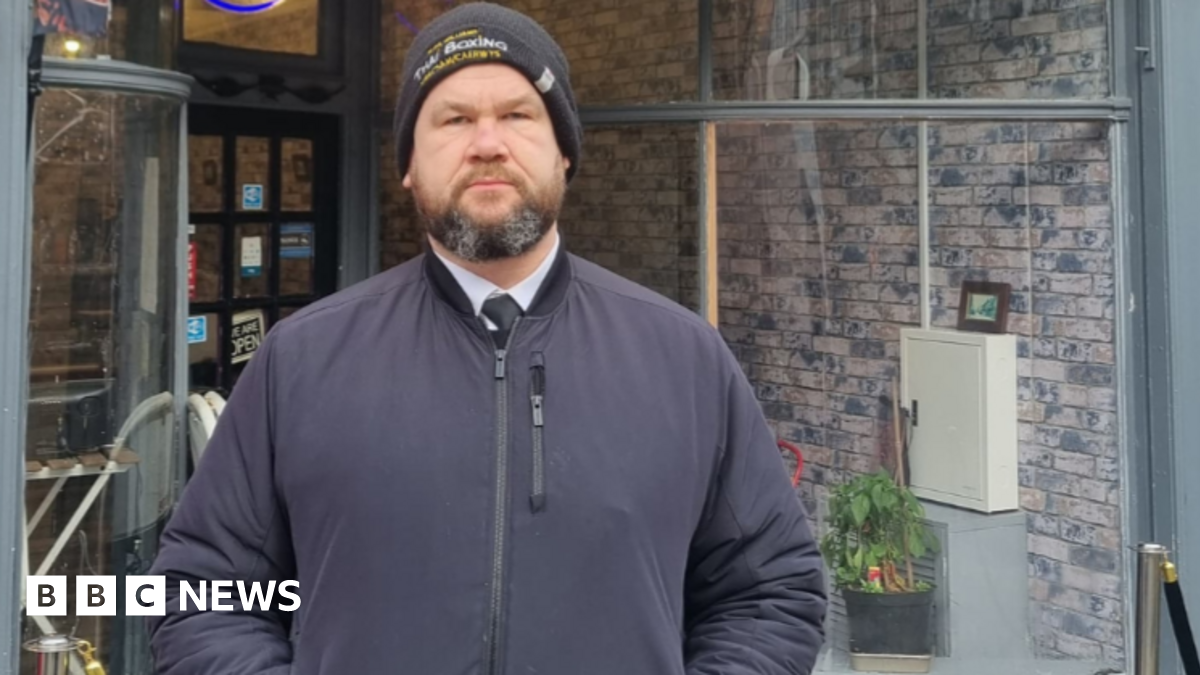 Martin Griffiths, wearing a wool hat and a jacket, standing with his hands in his pockets in front of the High Street Feeder cafe, near where the incident took place.