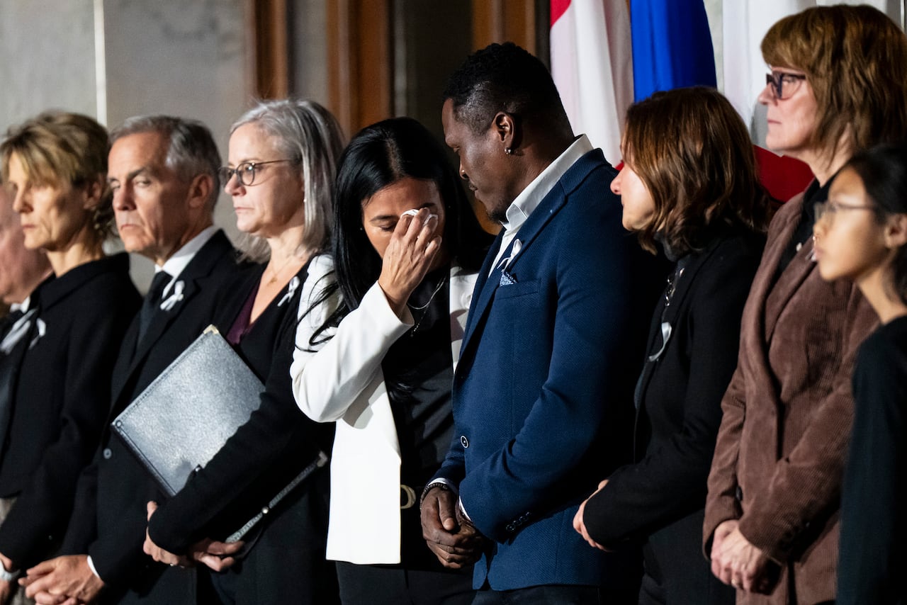 People stand a line during a ceremony to honour the 14 victims of a mass shooting in 1989.