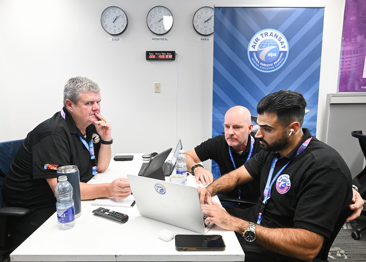 People sit at a desk.