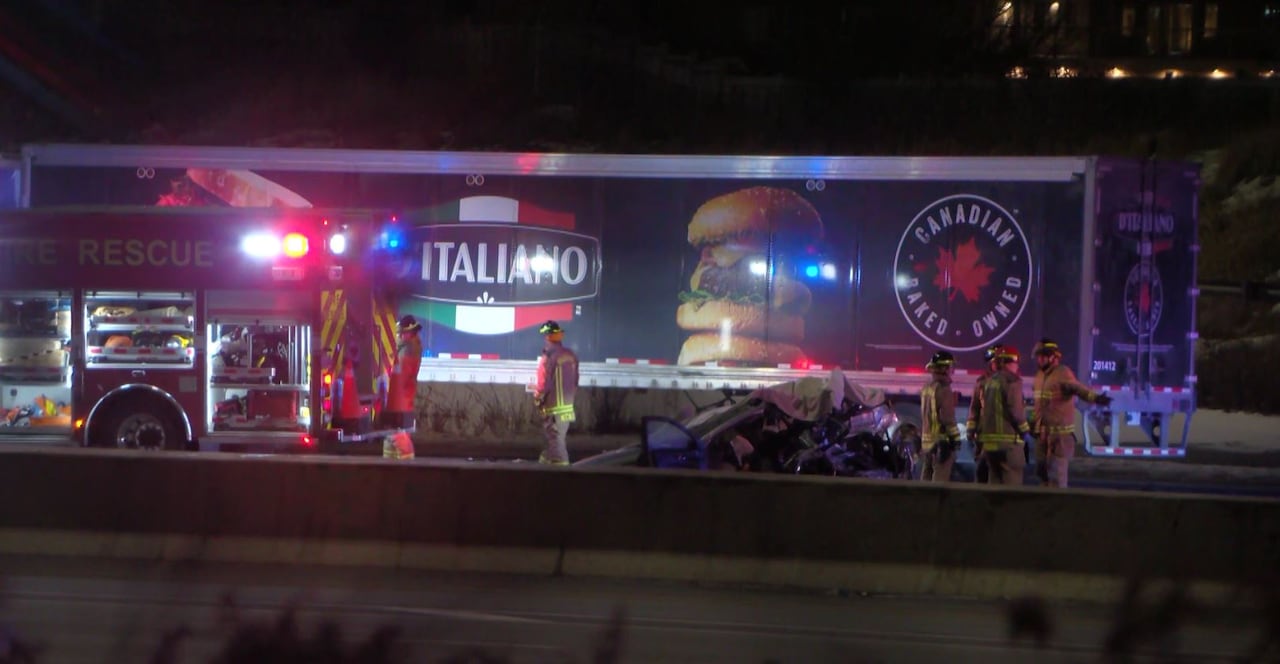 Firefighters stand near a crash site.