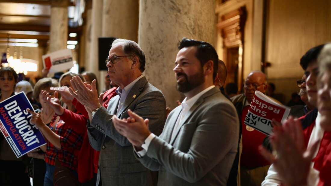 Republican Gov. Mike Braun (in glasses, center left) in the Indiana Capitol attends a rally last week in favor of redistricting that was organized by Turning Point Action.