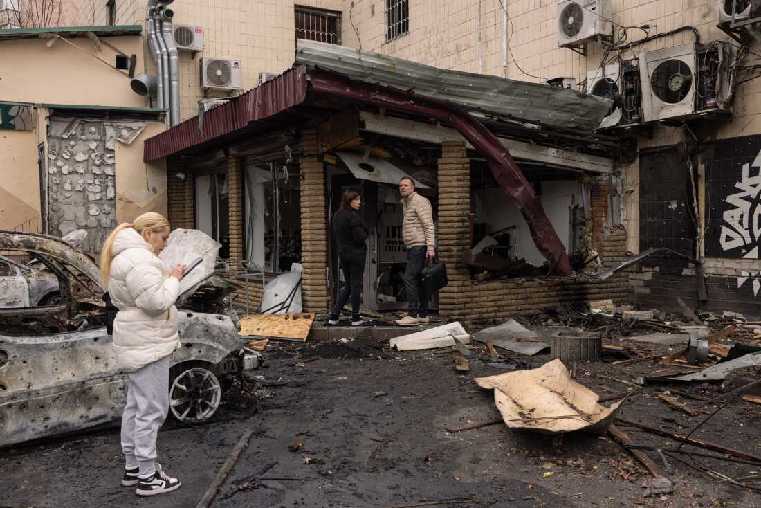 Shop owners survey the damage to their business hit by a drone strike on Nov. 29 in Kyiv, Ukraine.