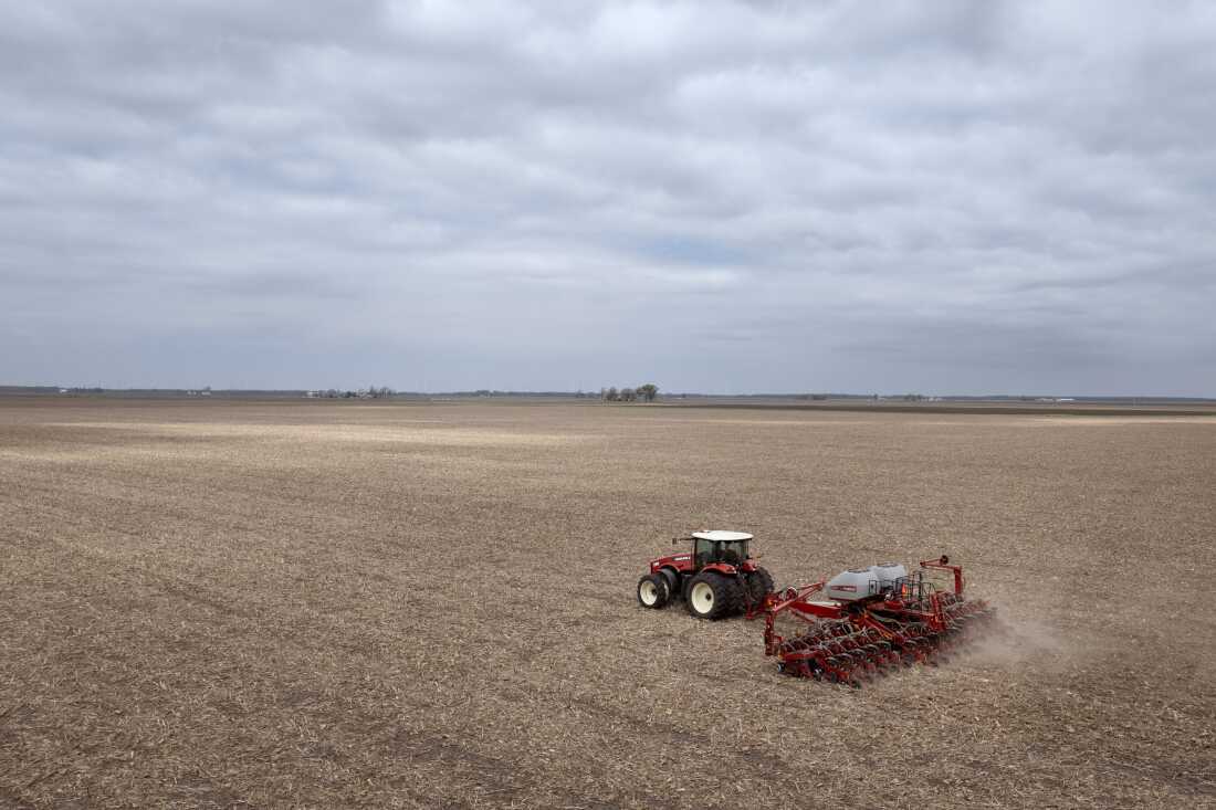 Dan Duffy uses a tractor to plant soybeans on land he farms with his brother on April 28, 2025 near Dwight, Illinois.
