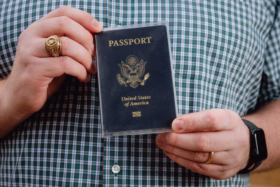 DENTON, TX - DECEMBER 07, 2025: Anthony Nel, 29, displays his passport at Quakertown Park in Denton, Texas, on Sunday, Dec. 7, 2025. Mr. Nel, a U.S. citizen for more than a decade and a regular voter for the past nine years, was flagged as a potential noncitizen in the SAVE data system and removed from the voter rolls after he did not respond to a county notice within 30 days. CREDIT: Desiree Rios for NPR