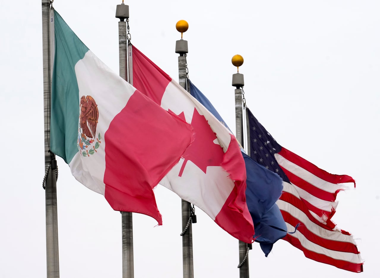 A Mexican, Canadian and American flag. 