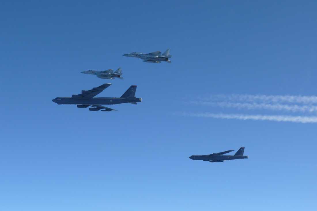 This photo provided by Japan's Ministry of Defense shows the Japan Air Self-Defense Force's F-15 fighters holding a joint military drill with U.S. B-52 bombers in the vicinity of Japanese airspace on Wednesday.