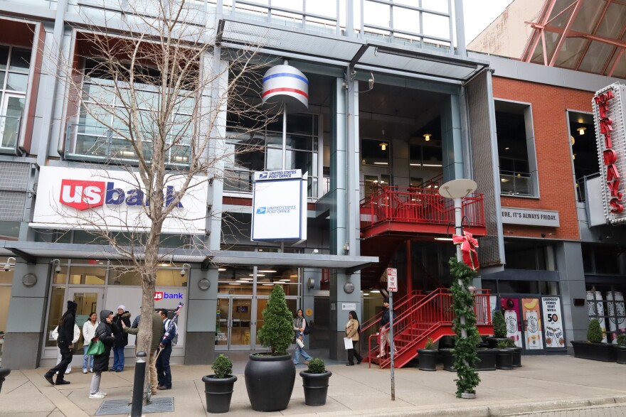 A group of people coming down from the second-floor USCIS office after a citizenship ceremony.