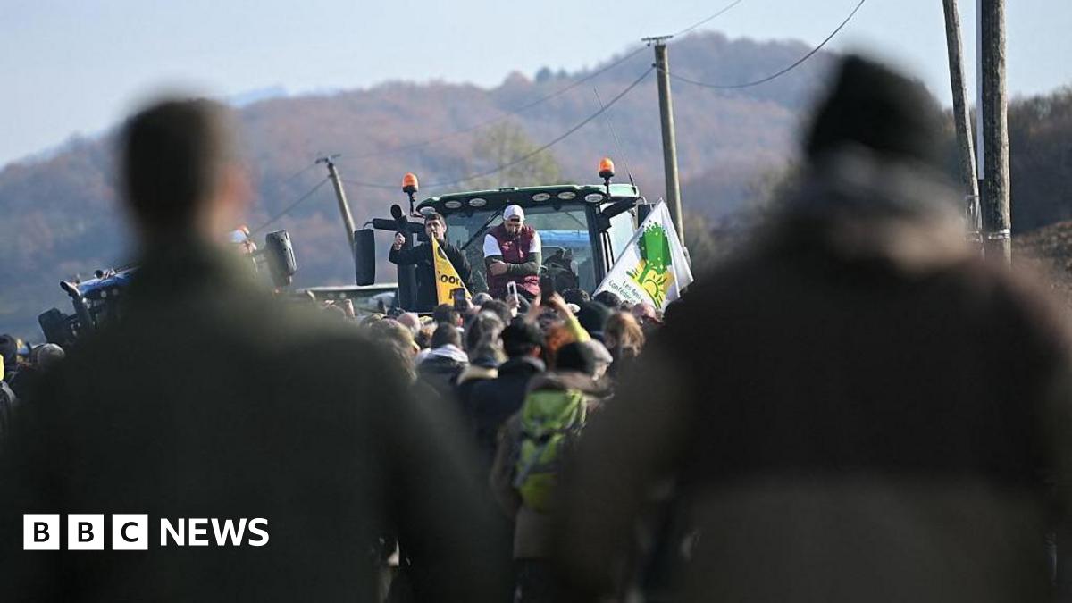 President of the Rural Coordination in Ariège Sebastien Durand and regional figure of the agricultural protest movement Jerome Bayle wave flags and chant to a crowd, who are attending a farmers' protest against the slaughter of a 200-cow herd, following detection of lumpy skin disease (LSD) in Les-Bordes-sur-Arize, France.