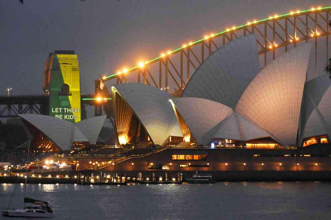 The social media ban for children under 16 slogan "Let Them Be Kids" is projected onto the pylons of the Sydney Harbour Bridge in Sydney, Wednesday, Dec. 10, 2025