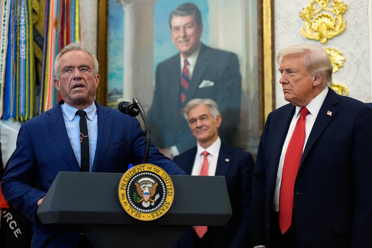 President Donald Trump listens as Health and Human Services Secretary Robert F. Kennedy Jr., speaks in the Oval Office