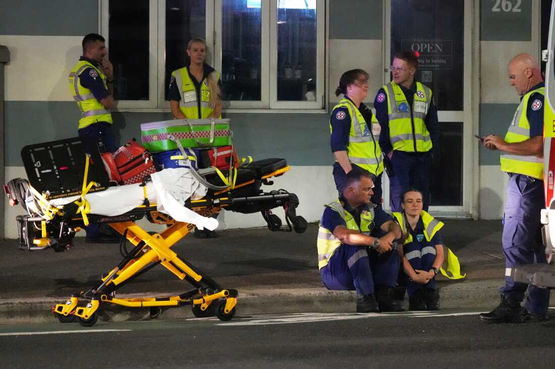 Emergency workers standby at Bondi Beach after a reported shooting in Sydney, Sunday, Dec. 14, 2025.