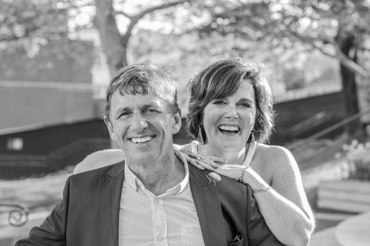A black and white photo of a smiling couple.