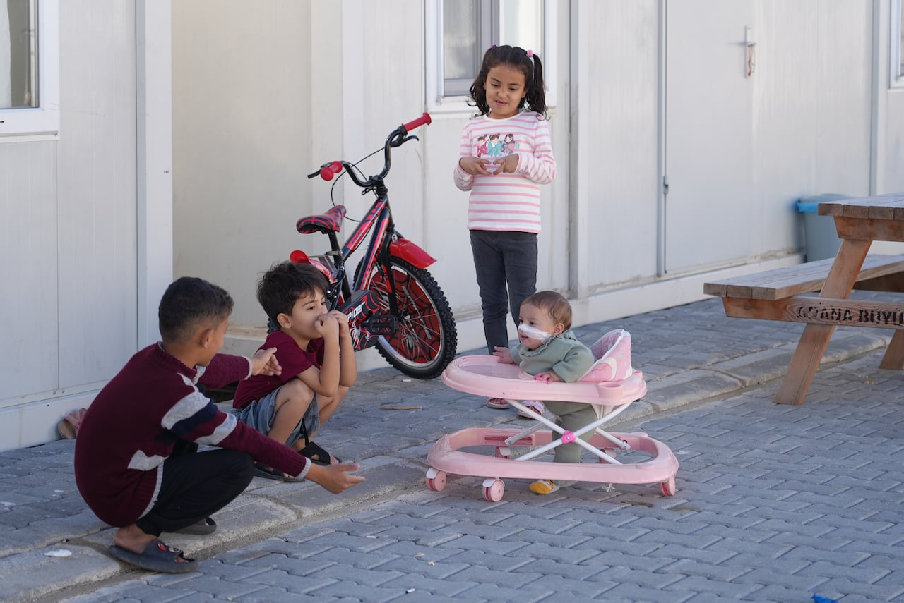 Habiba Abu Zarqa, along with her brother Hamad (far left) play with Karim and Sila Hammouda at the temporary housing settlement in Adana, Turkey 