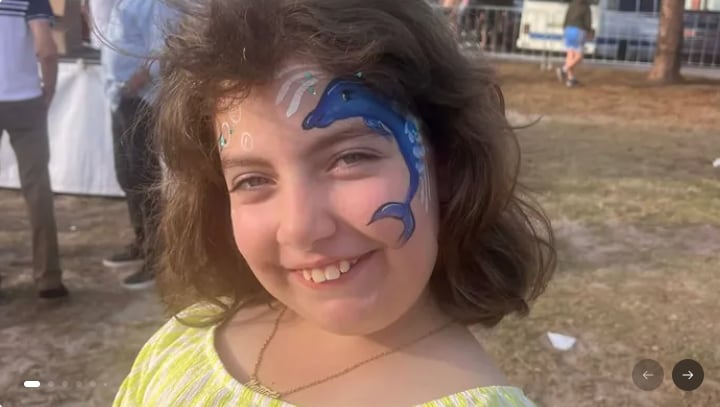A smiling girl with a painted face