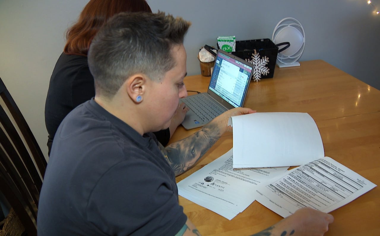 A person reading a document at a table.