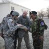 A U.S. Air Force captain goes over the day's mission route map with an Afghan National Army officer with assistance from an Afghan interpreter (left), before the U.S.-Afghan convoy sets off in Ghazni, Afghanistan, on March 16, 2009.