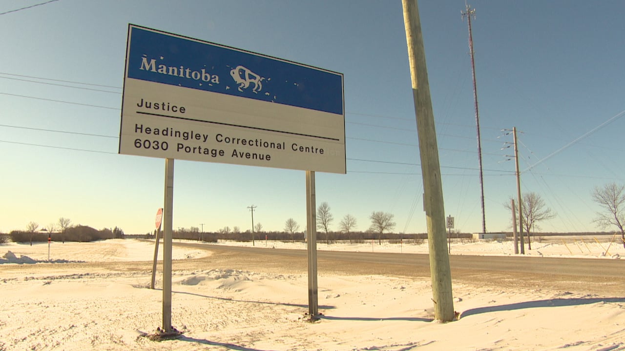 A sign next to a road reads, 'Manitoba Justice Headingley Correctional Centre 6030 Portage Avenue.'