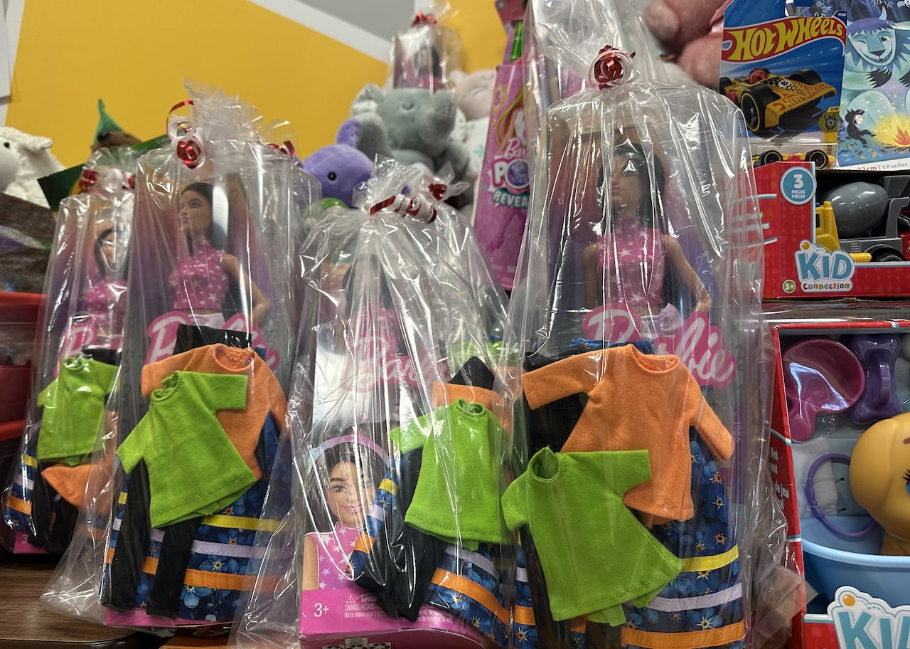 Four dolls in clear wrapping with handmade clothes and blue ribbon skirts