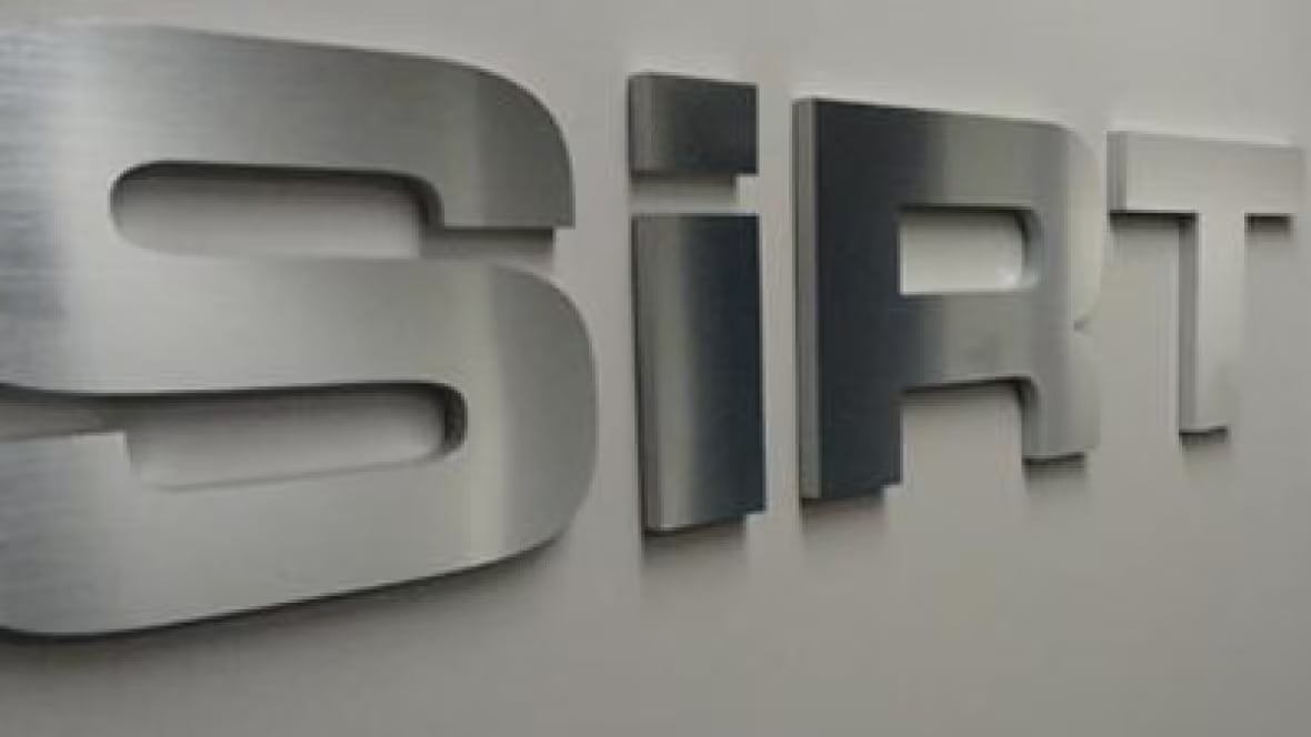 A closeup of silver letters 'SiRT' on a white wall.