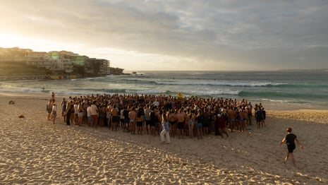‘This is our place’: hundreds form human circle on the beach and ocean at Bondi beach vigil – video