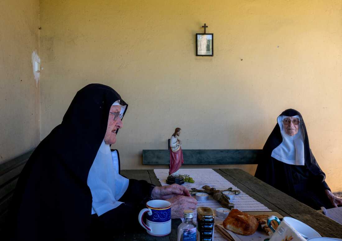 Sister Bernadette (left), and Sister Regina rest outside the convent chapel in September.