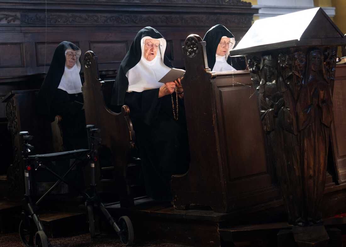 Sisters Rita, 81, Regina (left), 86, and Bernadette (center), 88, celebrate a mass with over a dozen of supporters and former students, at the convent chapel in September.