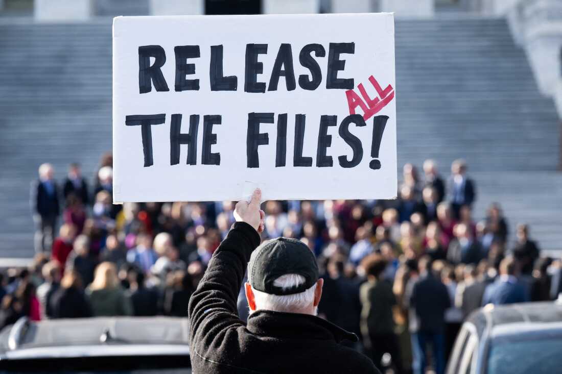 A protester holds a sign related to the release of the Jeffrey Epstein case files outside the U.S. Capitol in Washington, DC, on November 12, 2025.